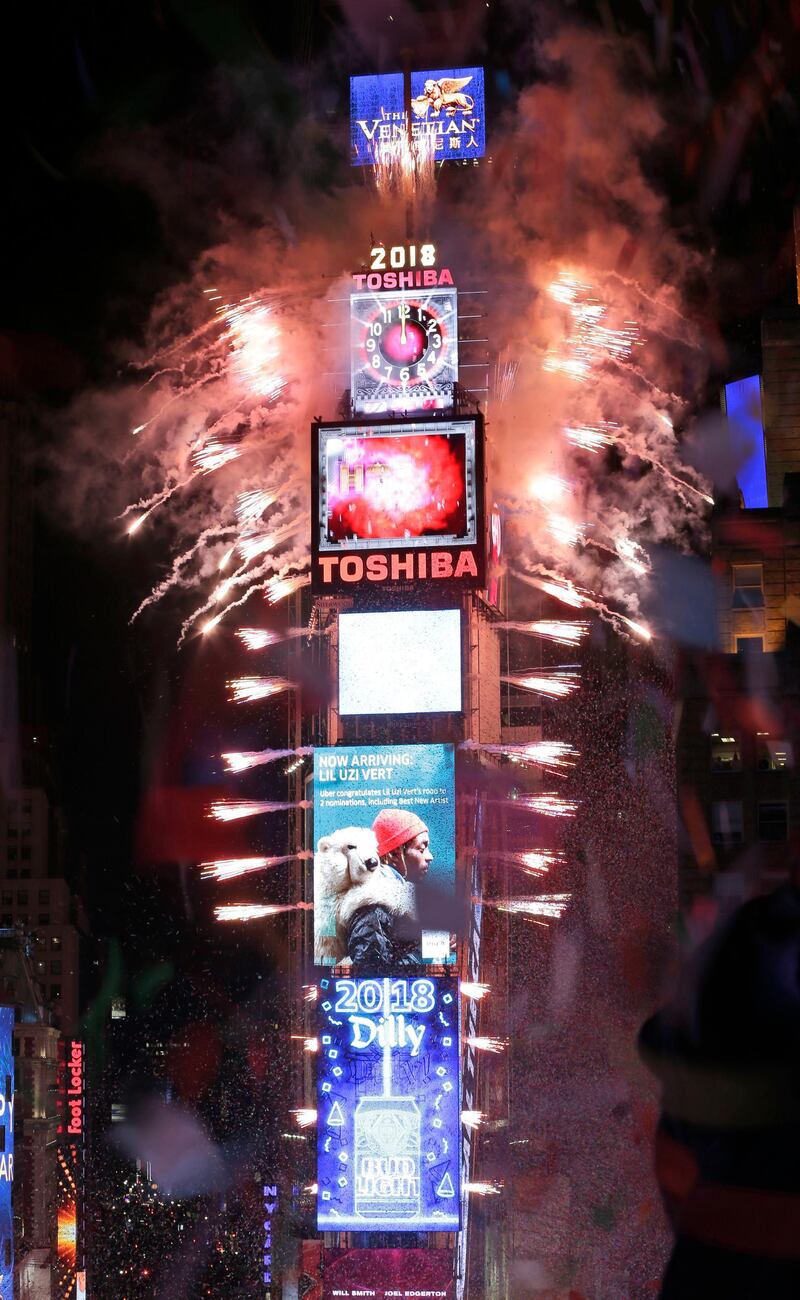 Fireworks erupt as the clock strikes midnight in New York City. Seth Wenig / AP Photo