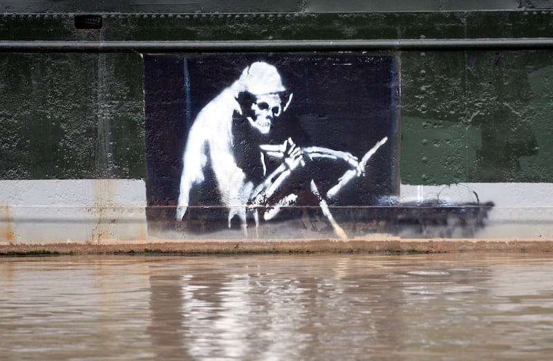 Grim Reaper by Banksy was displayed on the side of a boat moored in Bristol city centre until 2014, before it was moved to Bristol's M Shed. Getty Images