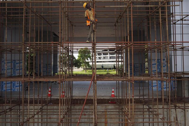 A man works at the National Arts Theatre stop of the light rail system under construction in Lagos, Nigeria, May 30, 2014. Started in 2009 to ease traffic, Lagos state government is building a rail system with the China Civil Engineering Construction Corporation. The first test runs should start in 2015, according to an official at the National Arts Theatre work site. Joe Penney / Reuters