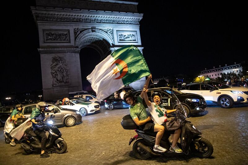 epaselect epa07728282 Algeria supporters celebrate on the Champs-Elysees, near the Arc de Triomphe, after Algeria won the 2019 Africa Cup of Nations (AFCON2019) final soccer match against Senegal, in Paris, France, 19 July 2019. The 2019 Africa Cup of Nations (AFCON2019) was taking place from 21 June until 19 July 2019 in Egypt.  EPA/IAN LANGSDON