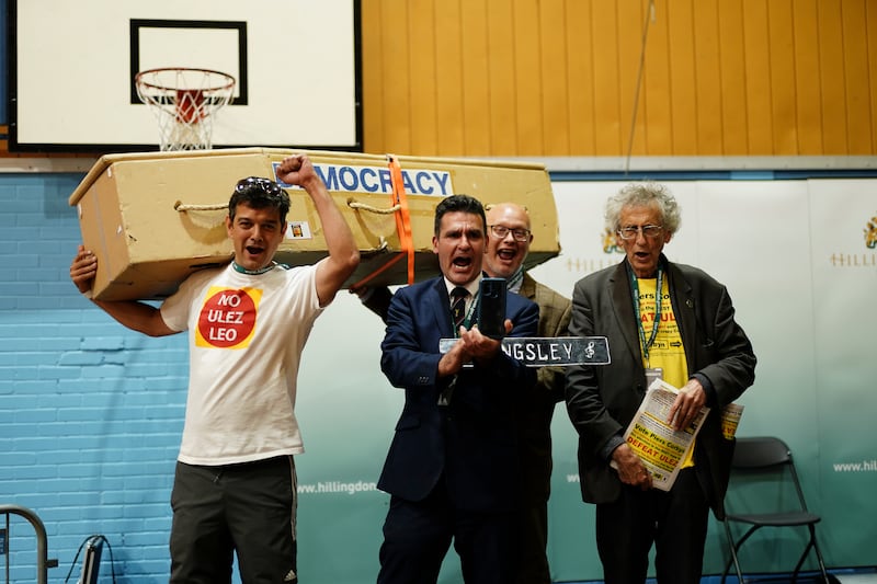 Candidates Leo Phaure, Kingsley Hamilton, Steve Gardner and Piers Corbyn stage an anti-Ulez protest on stage after Mr Tuckwell won the Uxbridge and South Ruislip by-election. PA