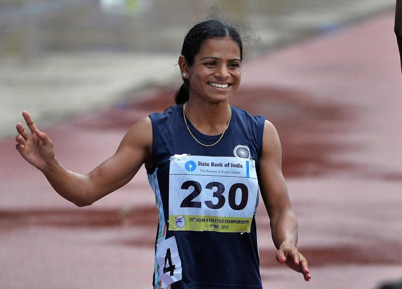 In this photograph taken on July 7, 2013, women's 200 meters bronze medal winners from India, Dutee Chand waves to the crowd after the race on the fifth and the final day of the Asian Athletics Championship 2013 at the Chatrapati Shivaji Stadium in Pune. Indian sprinter Dutee Chand on July 7, 2015 said she was "super excited" about competing again in top athletic events after international authorities set aside a ban imposed on her for failing a gender test. (AFP PHOTO/Manjunath Kiran/FILES)