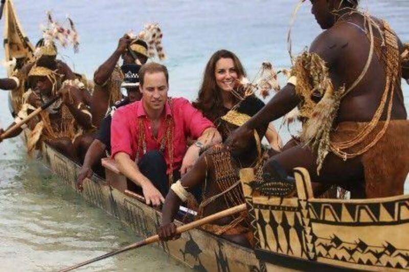 The Duke and Duchess of Cambridge on an official visit to the Solomon Islands yesterday. The royal family has launched an unprecedented legal battle in France over the publication of topless photographs of the Duchess.