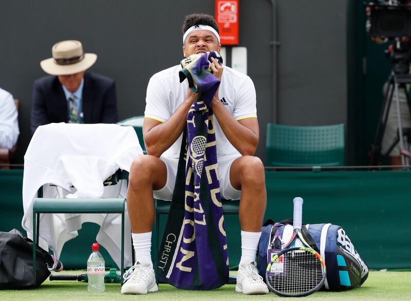 Jo-Wilfried Tsonga of France wipes his face as he prepares to resume his match with Sam Querrey of the United States.