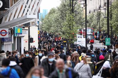 People walk at Oxford Street, as the coronavirus disease (COVID-19) restrictions ease, in London, Britain April 12, 2021. REUTERS/Henry Nicholls