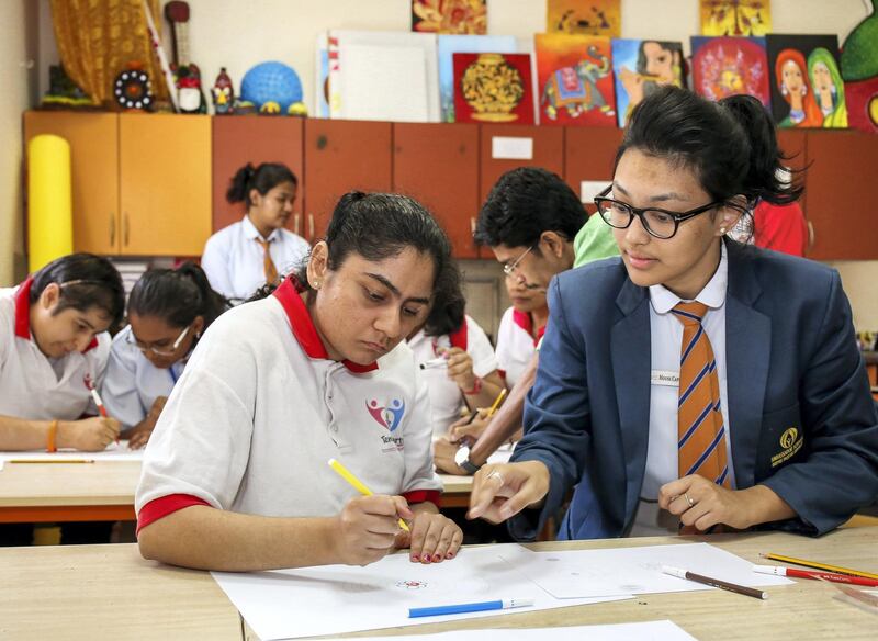 December 10, 2017.   Studentsf rom Ambassador school with students with disabilities from Tender Hearts school.  (L-R) Heena Pancholia is assisted by Meghna Shresta of Ambassador school during art class.
Victor Besa for The National
National
Reporter:  Ramola Talwar