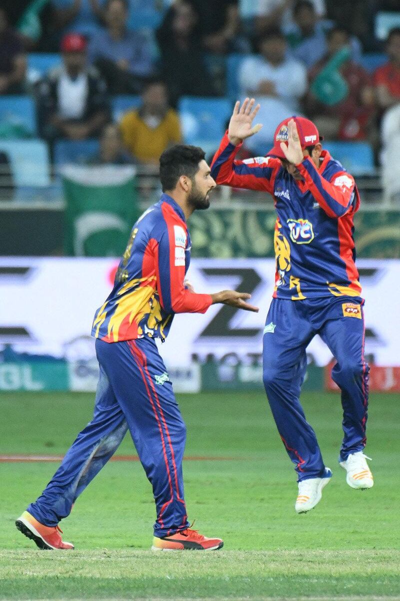 Karachi Kings players celebrate the dismissal of a Lahore Qalandars batsman.