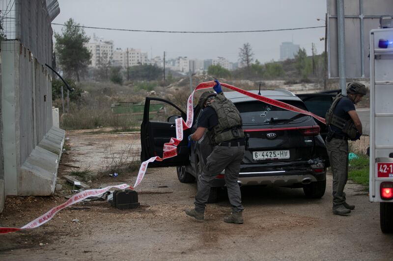 Israeli troops collect evidence after an Israeli soldier was injured in a car-ramming attack near the Israeli settlement of Kochav Yakov in the West Bank. AP