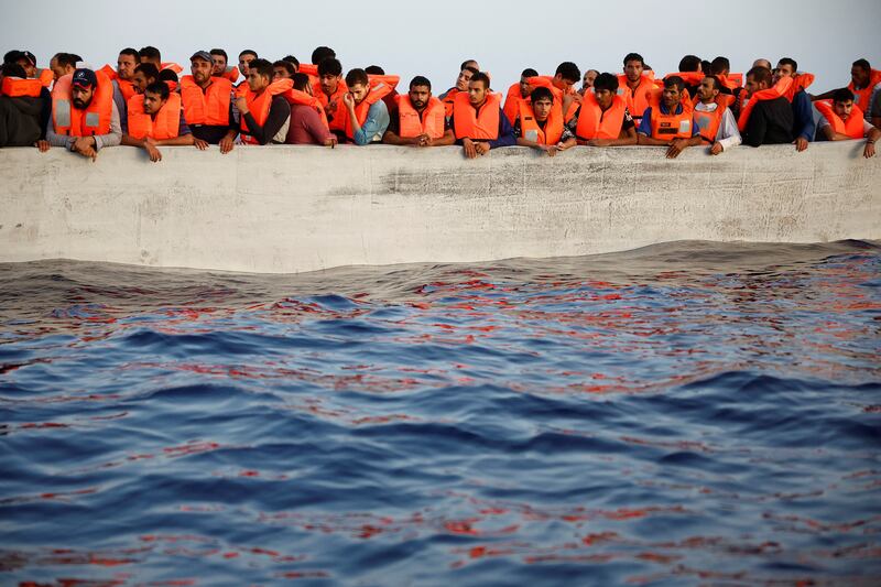 Migrants wait in a boat during a search and rescue operation by the NGO Proactiva Open Arms in the central Mediterranean in August, 2022. Reuters