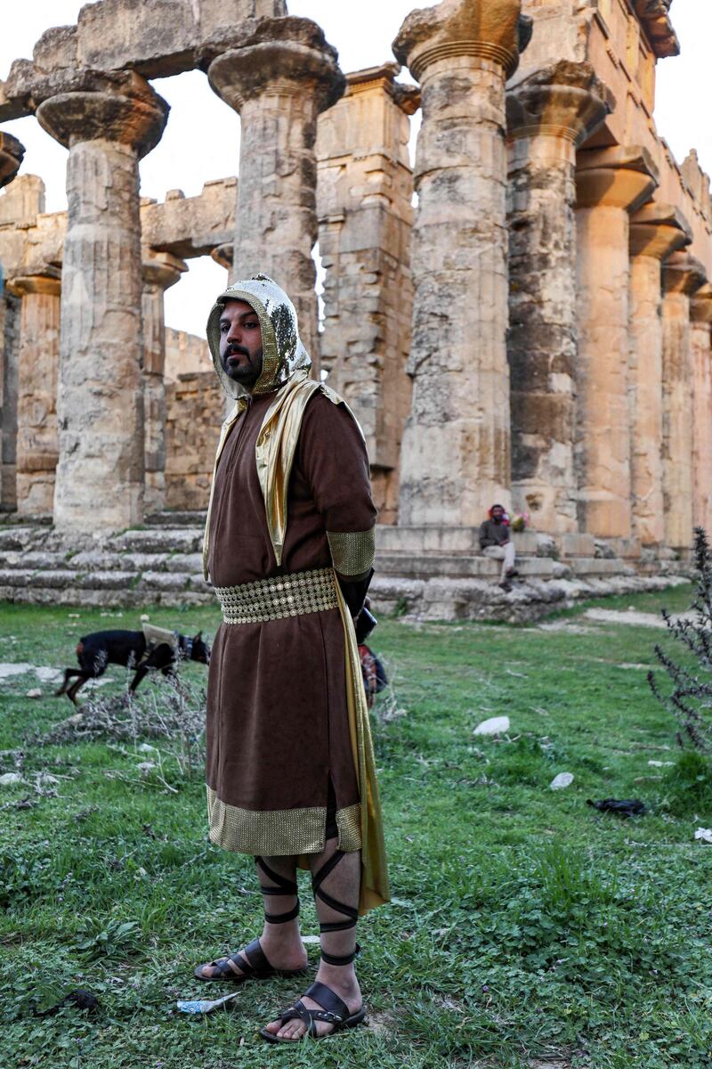 A actor in costume stands near the Temple of Zeus in the ruins of Libya's ancient eastern city of Cyrene during the filming of a television production. AFP