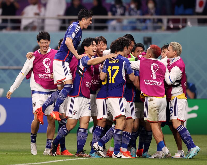 Ao Tanaka celebrates with the Japan squad after scoring. Getty