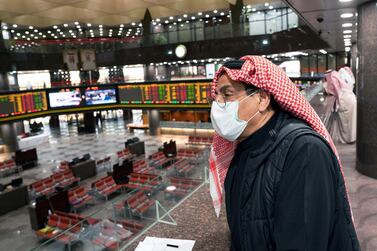 A Kuwaiti trader wears a protective face mask, following the outbreak of the new coronavirus. Trading was suspended last week in the country's premier market after shares hit the maximum daily decline limit of 10%. Reuters