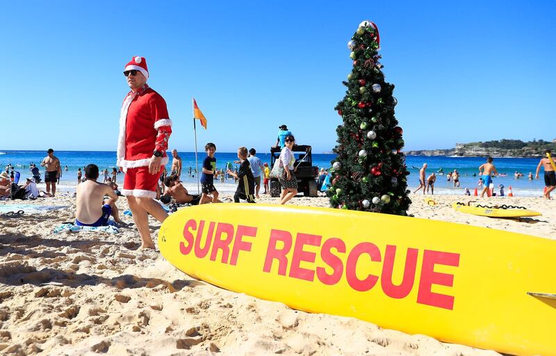 A man dressed  as Santa poses next to a Christmas tree on Bondi Beach in Sydney, Australia. December is one of the hottest months of the year across Australia, with Christmas Day traditionally involving a trip to the beach and celebrations outdoors. Getty