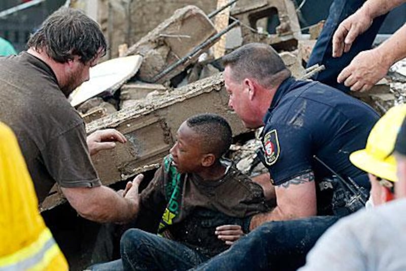 A boy is pulled from beneth the rubble at the Plaza Towers Elementary School which was directly hit by a tornado in Moore, Oklahoma.