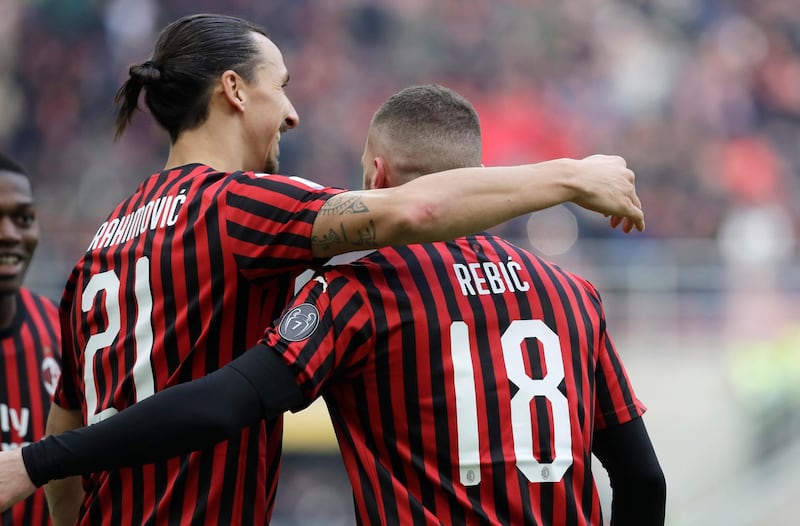 AC Milan's Ante Rebic, right, celebrates with his teammate Zlatan Ibrahimovic after scoring his side's opening goal during a Serie A soccer match between AC Milan and Udinese, at the San Siro stadium in Milan, Italy, Sunday, Jan. 19, 2020. (AP Photo/Luca Bruno)