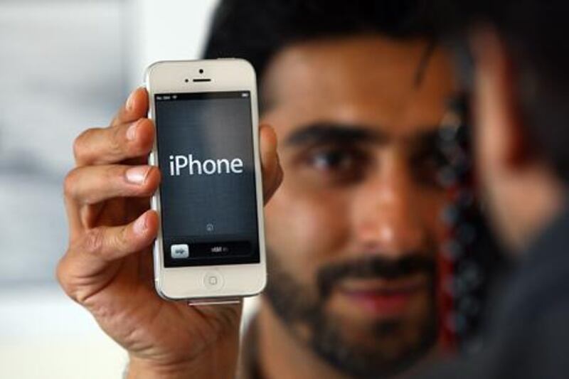Apple fans don't have to wait much longer for the iPhone 5 which has only been available on the grey market in UAE. Satish Kumar / The National