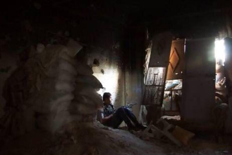 A Free Syrian Army fighter sits near sandbags inside a damaged room in Deir Al Zor. Many young fighters are disillusioned with the revolution and unsure about the purpose of fighting on.