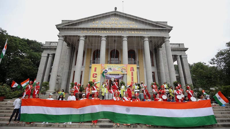 A giant Indian national flag is unfurled in front of the town hall, to mark the country's Independence Day, in Bangalore. EPA