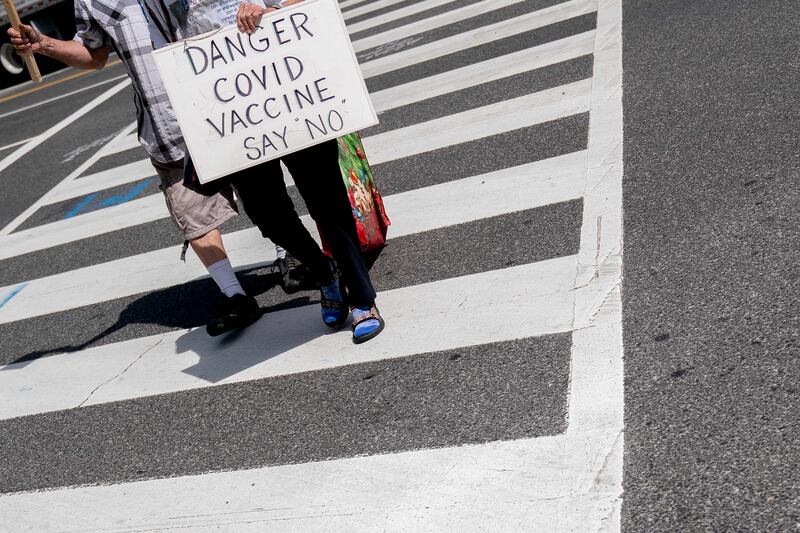 A person carries a sign protesting Covid-19 vaccines in Washington. AFP