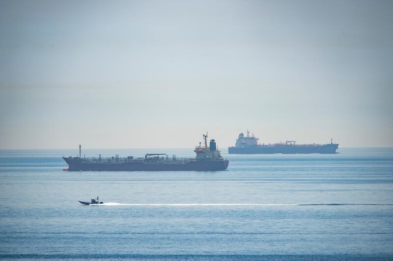 A view of the vessel the Clavel, right, sailing on international waters crossing the Gibraltar stretch on Wednesday, May 20, 2020. Five Iranian tankers likely carrying at least $45.5 million worth of gasoline and similar products are now sailing to Venezuela, part of a wider deal between the two U.S.-sanctioned nations amid heightened tensions between Tehran and Washington. (AP Photo/Marcos Moreno)