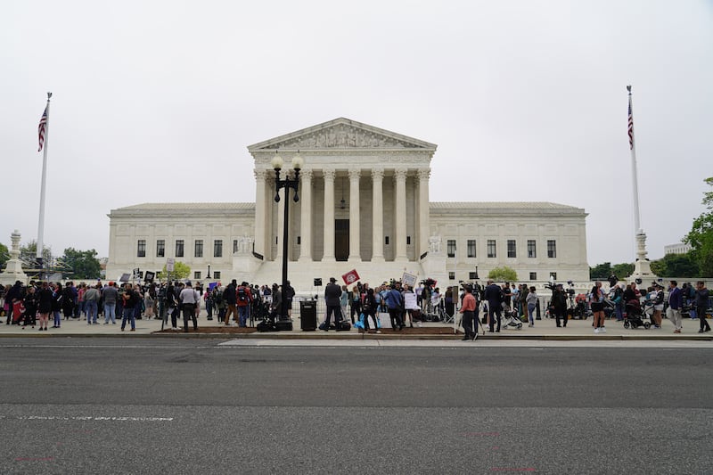 People gather in front of the Supreme Court in Washington on Tuesday, May 3, 2022. Willy Lowry / The National