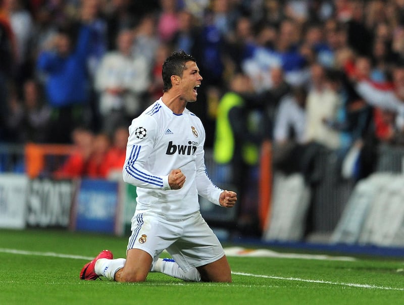 MADRID, SPAIN - OCTOBER 19:  Cristiano Ronaldo of Real Madrid celebrates scoring his sides opening goal from a free kick during the UEFA Champions League group G match between Real Madrid and AC Milan at the Estadio Santiago Bernabeu on October 19, 2010 in Madrid, Spain.  (Photo by Jasper Juinen/Getty Images)