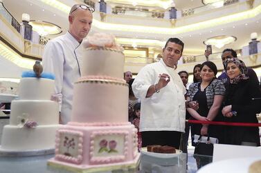 The Cake Boss, Buddy Valastro Jr, treated sisters Sara and Soha with a few tips on the two cakes they entered in the individual category at the cake contest held at Emirates Palace on Saturday. Delores Johnson / The National