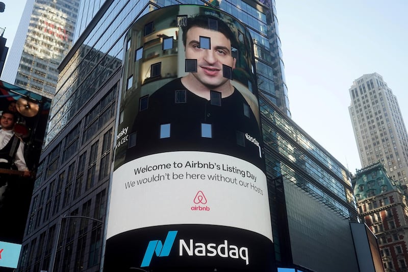 FILE PHOTO: The Nasdaq market site displays an Airbnb sign featuring CEO Brian Chesky on their billboard on the day of their IPO in Times Square in the Manhattan borough of New York City, New York, U.S., December 10, 2020. REUTERS/Carlo Allegri/File Photo