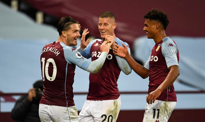 BIRMINGHAM, ENGLAND - OCTOBER 04: Jack Grealish of Aston Villa celebrates with Ross Barkley of Aston Villa and Ollie Watkins of Aston Villa  after he scores his sides 7th goal during the Premier League match between Aston Villa and Liverpool at Villa Park on October 04, 2020 in Birmingham, England. Sporting stadiums around the UK remain under strict restrictions due to the Coronavirus Pandemic as Government social distancing laws prohibit fans inside venues resulting in games being played behind closed doors. (Photo by Peter Powell - Pool/Getty Images)