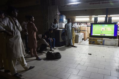 Cricket fans watch a live telecast of T20 cricket World Cup match between Pakistan and India on a screen in Karachi, on October 24. AFP