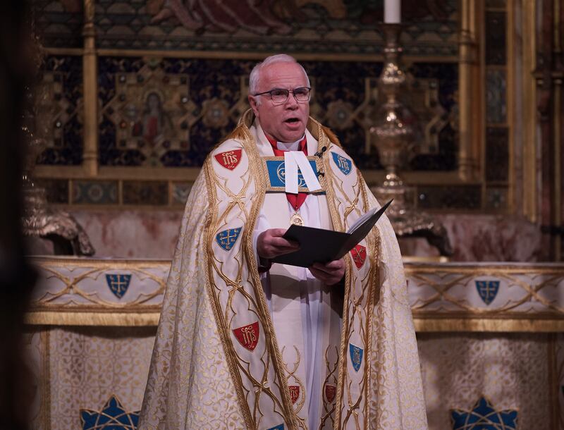 Dean of Westminster David Hoyle gives a reading during the service. PA