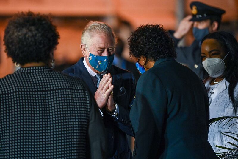 The Prince of Wales is greeted by Dame Sandra Mason shortly after he touches down in Barbados. AFP