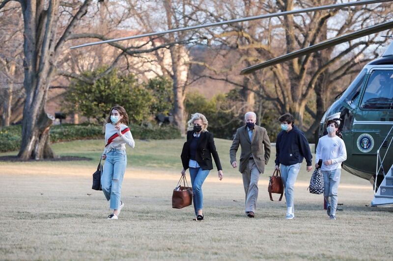 U.S. President Joe Biden walks with first lady Jill Biden and their grandchildren Natalie, Hunter and a family friend, from Marine One on the South Lawn of the White House in Washington, U.S., March 14, 2021. REUTERS/Cheriss May