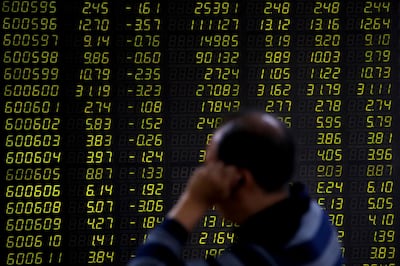 An investor sits in front of an electronic board displaying stock prices at a brokerage house in Beijing, Monday, Sept. 17, 2018. Asian shares were mostly lower Monday on reports that President Donald Trump will soon place tariffs on $200 billion more of Chinese goods, even as officials worked to iron out tensions between the world's two largest economies. (AP Photo/Andy Wong)