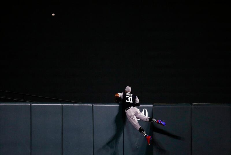 New York Yankees center fielder Aaron Hicks watches as a solo home run ball that was hit by Baltimore Orioles' Chris Davis sails over the outfield wall in the 10th inning of a baseball game. AP