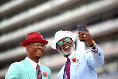 DUBAI, UNITED ARAB EMIRATES - MARCH 30: Two fans take a selfie photograph during the Dubai World Cup at Meydan Racecourse on March 30, 2019 in Dubai, United Arab Emirates. (Photo by Francois Nel/Getty Images)