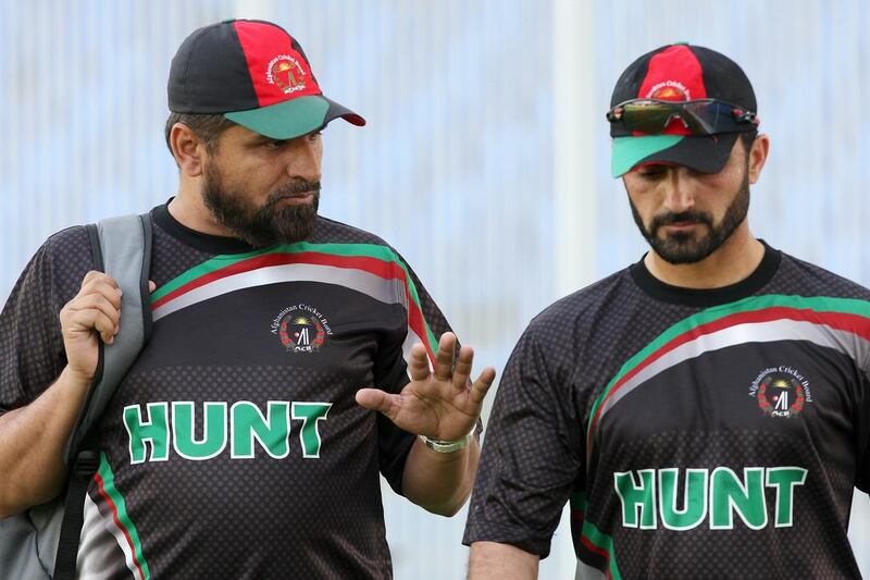 Afghanistan cricket coach Kabir Khan, left, chats with Afghan cricketer Nawroz Mangal during a practice in Sharjah in March. Pawan Singh / The National / March 1, 2014