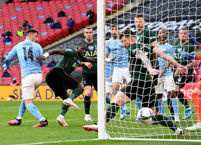 City's Aymeric Laporte, left, heads home the winner. EPA