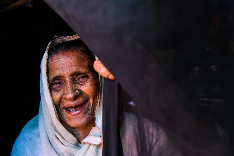 Rohingya refugee, Gulzar, 60, gestures as she stands at the entrance of her tent in Kutupalong refugee camp in Ukhia near Cox's Bazar. Chandan Khanna/AFP