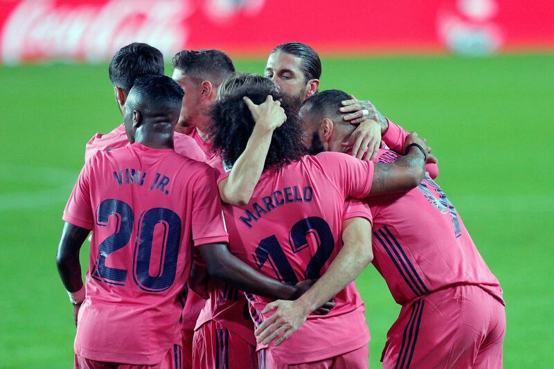 Benzema (R) celebrates with teammates. EPA