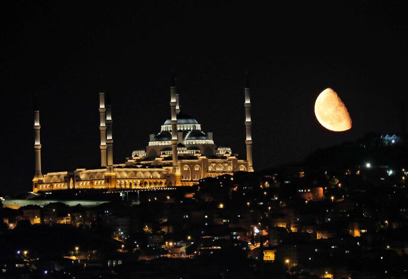 The moon rises over the Grand Camlica Mosque in Istanbul, Turkey.  Reuters