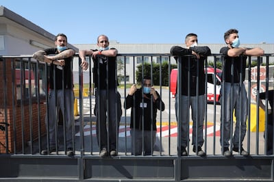 Workers stand on a gate to watch a demonstration outside the Nissan Motor Co. plant in Barcelona, Spain, on Thursday, May 28, 2020. Nissan said it intends to close its Barcelona plant, in addition to the one it is planning to shutter in Indonesia. Photographer: Angel Garcia/Bloomberg
