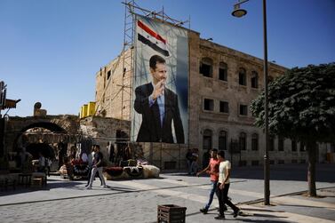 A poster of Syrian President Bashar Al Assad in the old city of Aleppo. The country's second vote in the shadow of civil war is seen as likely to keep President Al Assad in power. AFP