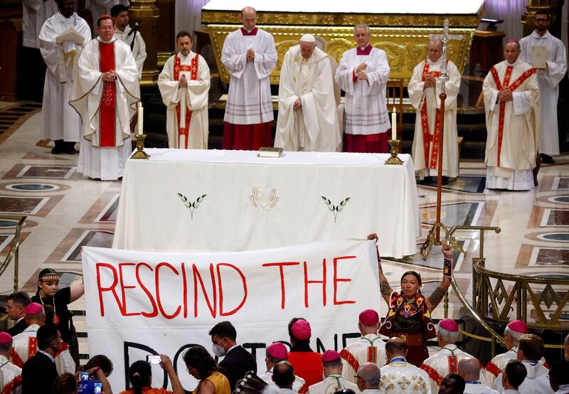 Indigenous people hold a banner as Pope Francis presides over a mass in Sainte-Anne-de-Beaupre. Reuters