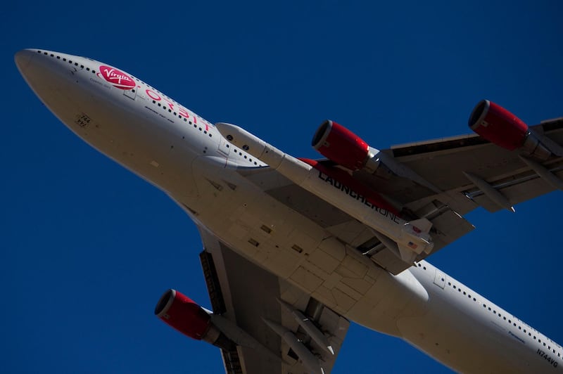 The Virgin Orbit "Cosmic Girl" - a modified Boeing Co. 747-400 carrying a LauncherOne rocket under it's wing - takes off for the Launch Demo 2 mission from Mojave Air and Space Port on January 17, 2021 in Mojave, California. - The LauncherOne rocket, which will release from the wing of the Boeing 747 before ignition, contains small research satellites, known as CubeSats for NASA's Educational Launch of Nanosatellites (ELaNa) 20 mission developed by nine research universities and a NASA center. (Photo by Patrick T. FALLON / AFP)