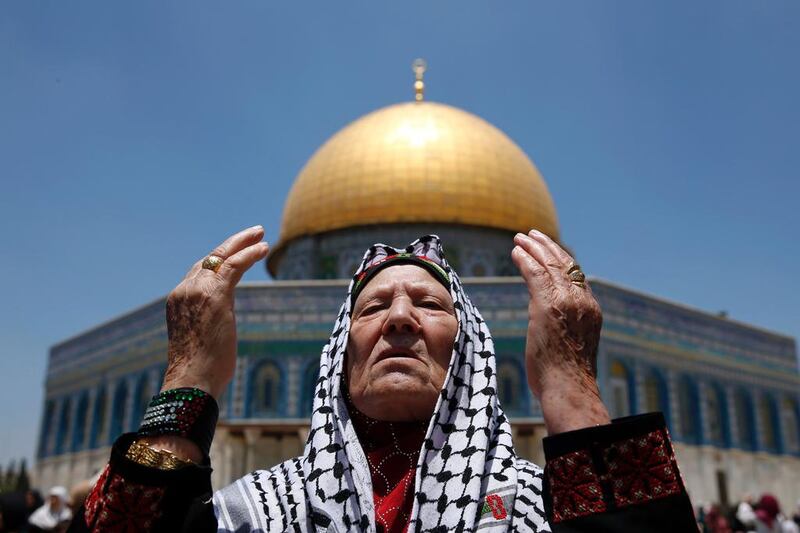 A Palestinian Muslim worshipper attends the first Friday prayers of Ramadan in front of the Dome of the Rock at Jerusalem’s Al Aqsa mosque compound. AFP