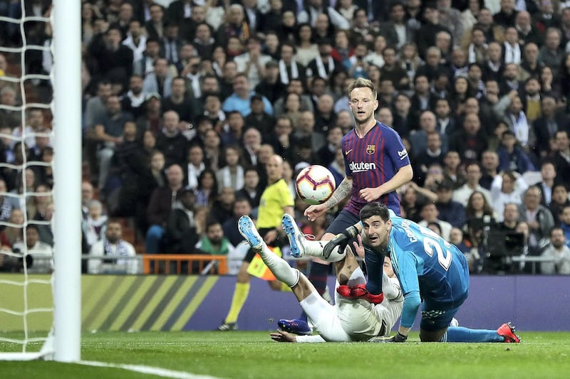 MADRID, SPAIN - MARCH 02: Ivan Rakitic of Barcelona scores his sides first goal past Thibaut Courtois and Sergio Ramos of Real Madrid during the La Liga match between Real Madrid CF and FC Barcelona at Estadio Santiago Bernabeu on March 02, 2019 in Madrid, Spain. (Photo by Gonzalo Arroyo Moreno/Getty Images)