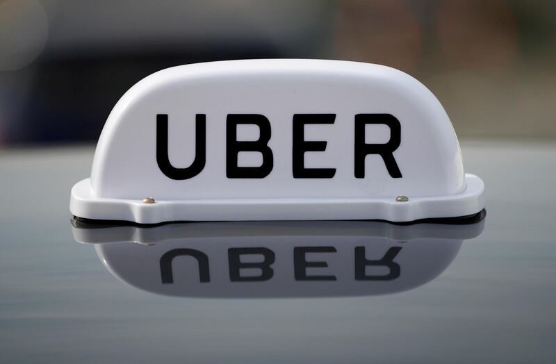 FILE PHOTO: The Logo of taxi company Uber is seen on the roof of a private hire taxi in Liverpool, Britain, April 15, 2019. REUTERS/Phil Noble/File Photo