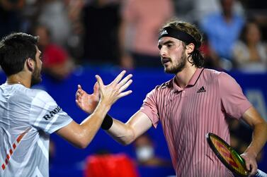 Britain's Cameron Norrie (L) shakes hands with Greece's Stefanos Tsitsipas at the net following their Mexico ATP Open 500 men's singles semi-final tennis match at the Arena GNP, in Acapulco, Mexico, on February 25, 2022.  (Photo by PEDRO PARDO  /  AFP)