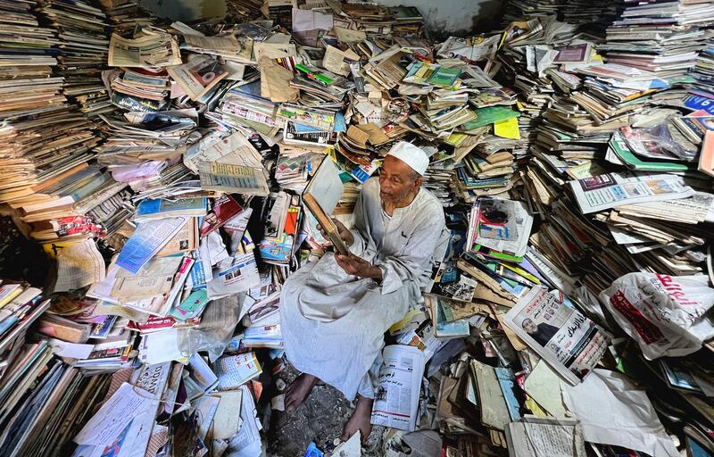 Abdallaa Abu Dawh, 82, a former teacher at Egypt's Al-Azhar university, reads in his basement home which contains about 15,000 books collected in the course of his life in the hope of offering young people in his village in the Nile Delta books to read for free. Reuters